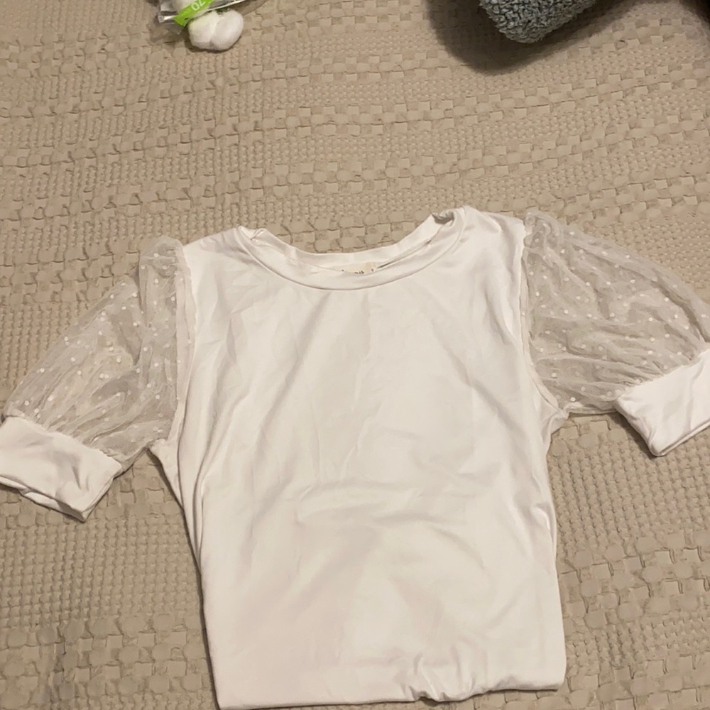 White shirt with polka dotted see-through sleeves